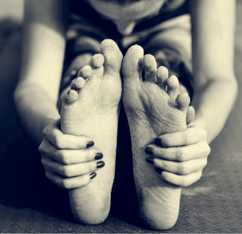 Yoga model holding feet